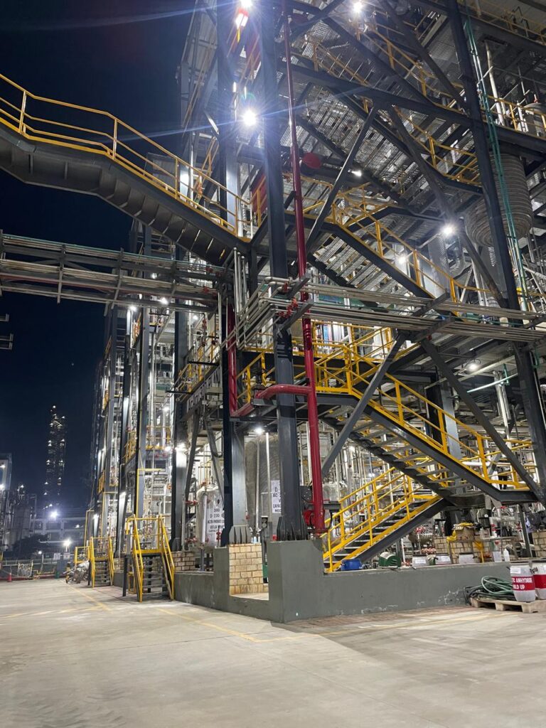 Industrial pipework and process equipment beside access stairs