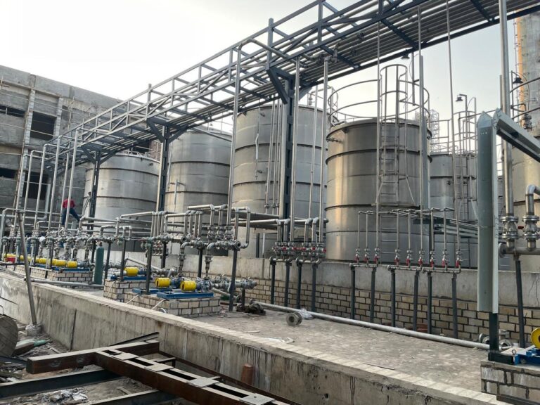 Tank-side pumps, valves and overhead pipe rack