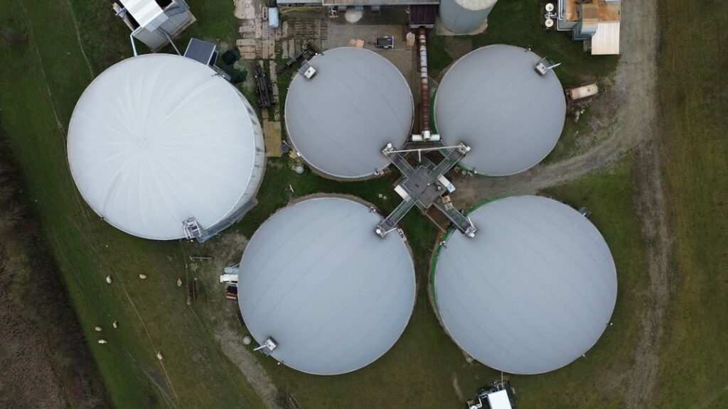 Aerial view of covered circular tanks at a biogas plant